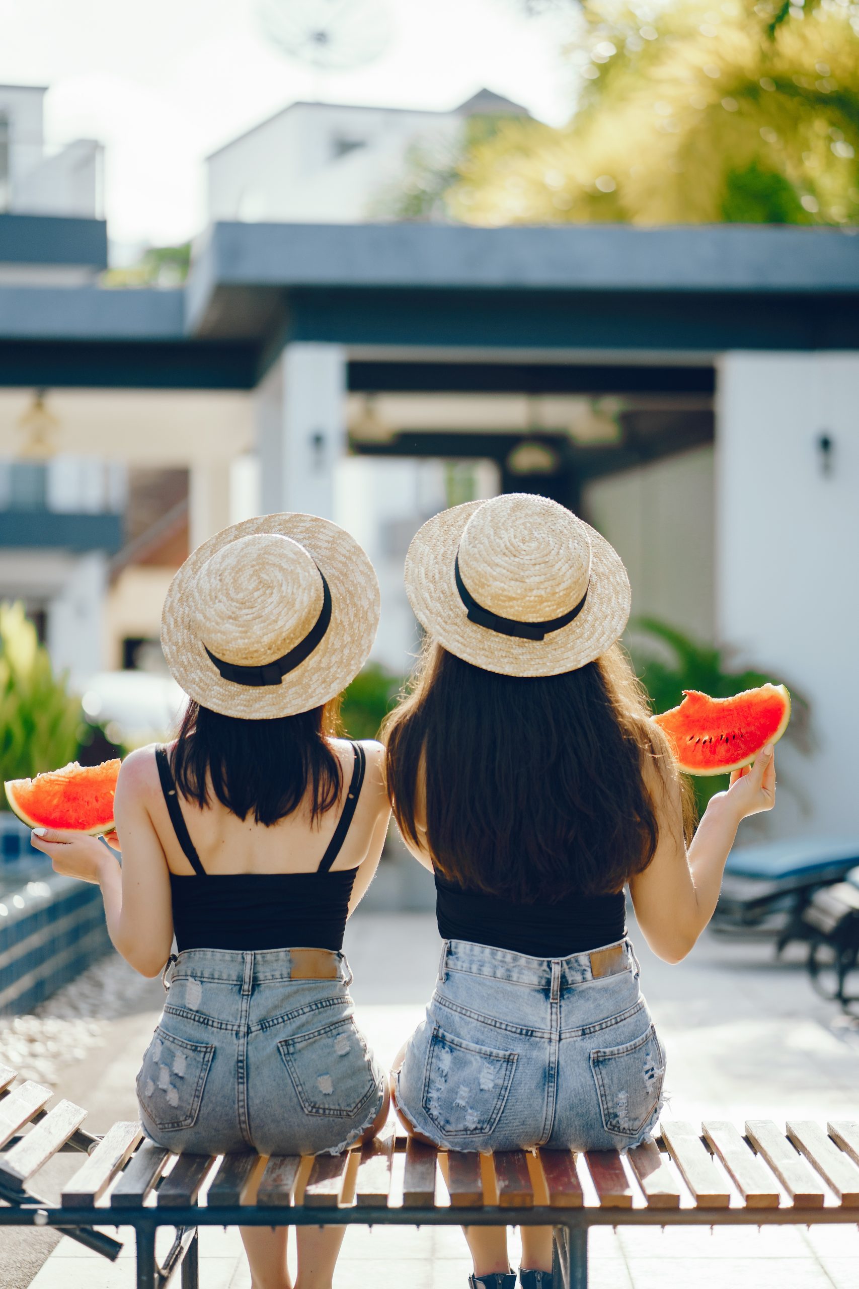 two girls eating watermelon