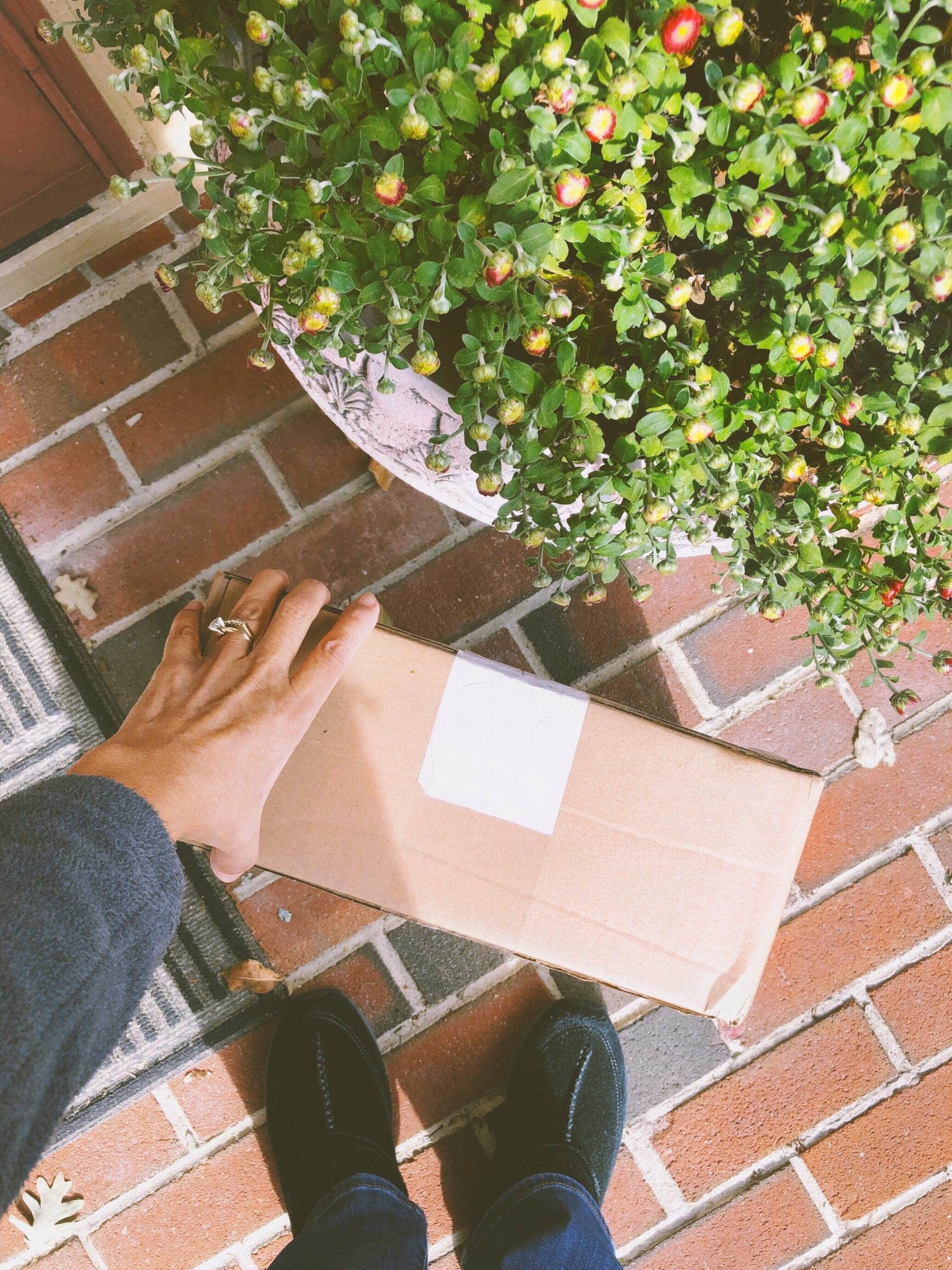 woman-picking-a-package-delivered-at-the-front-doo-2021-08-31-10-27-20-utc